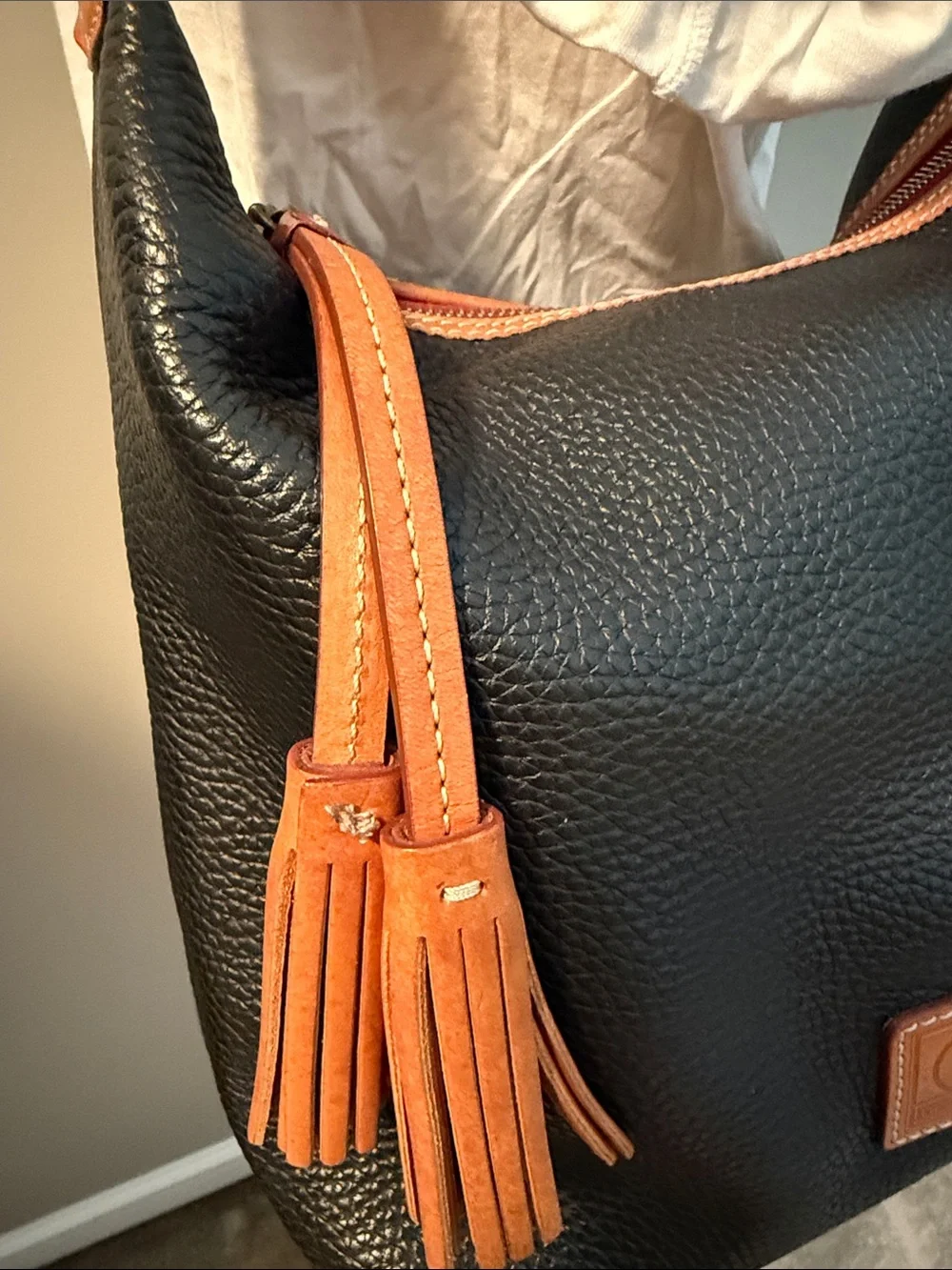 Dooney & Bourke Black and Tan Pebbled Leather Hobo with Tassel